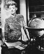 Bette Davis - Bette Davis Posed Leaning on the Table in Black Polka Dot Long Sleeve Shirt and Pearl Necklace