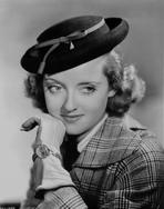 Bette Davis - Bette Davis Portrait in Flat Top Hat with Chin Leaning on Hand in Checkered Suit and Black Tie